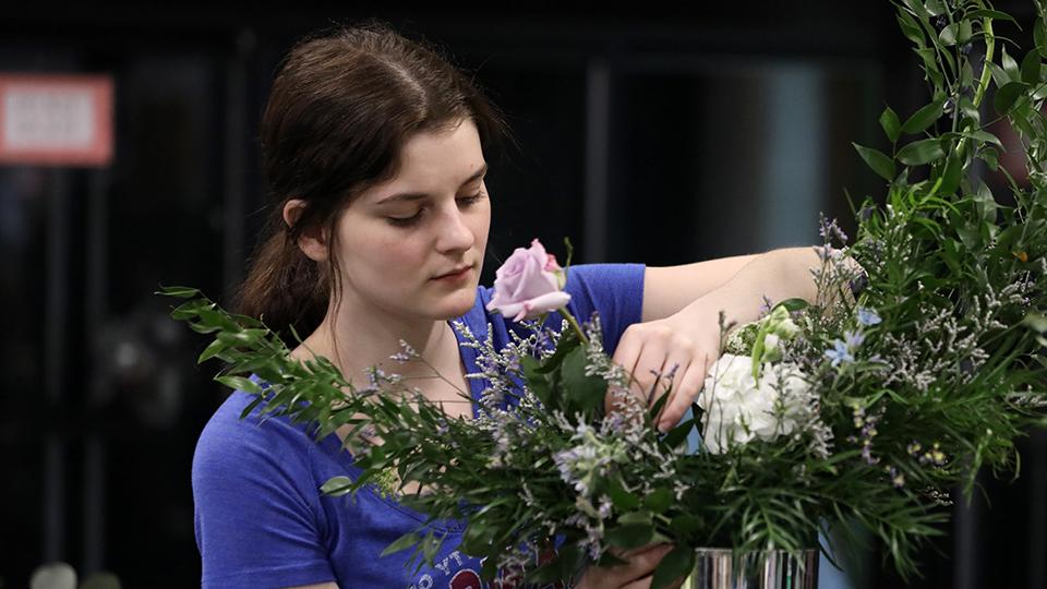 A student working on a floral arrangement