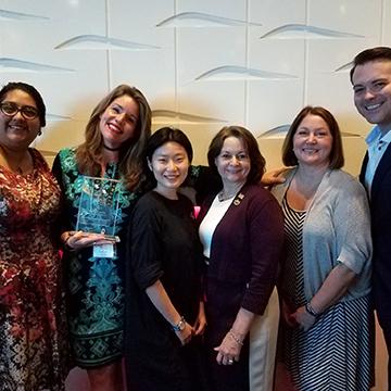 Group photo with a trophy from the Symphony Showhouse