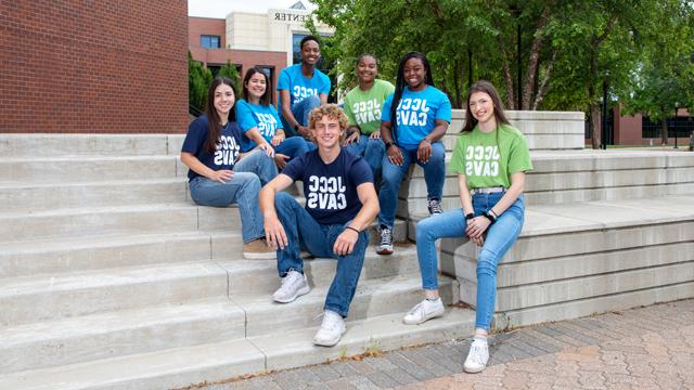 Student ambassadors sitting on the steps in the COM courtyard